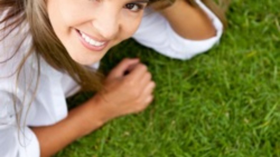 Smiling Woman On Grass - weight loss programs in charlotte