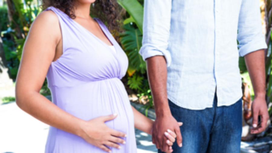 Pregnant Couple Holding Hands - autoimmune treatment in charlotte