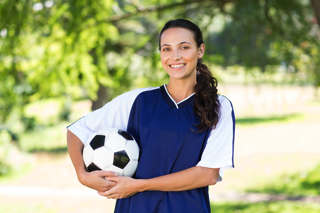 Woman Holding Soccer Ball - charlotte crohn's disease treatment