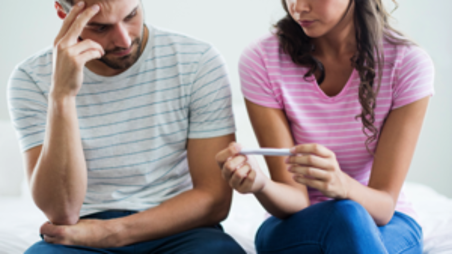 Couple With Pregnancy Test - charlotte autoimmune disorder treatment