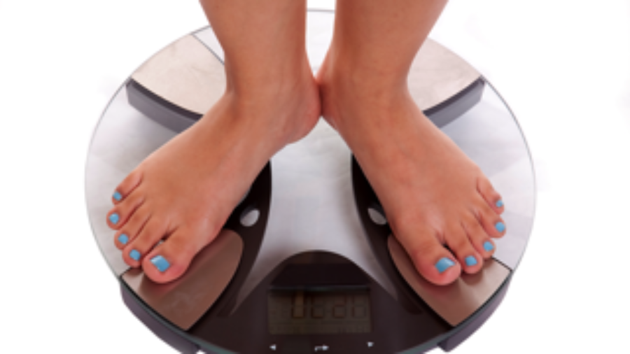 Person Weighing Themselves - charlotte functional wellness